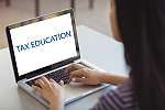 Schoolgirl using laptop in classroom at school