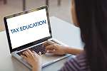 Schoolgirl using laptop in classroom at school